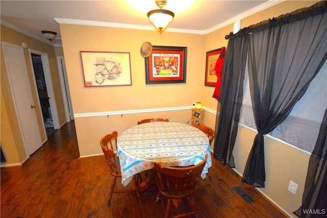 dining room featuring baseboards, crown molding, visible vents, and dark wood-type flooring