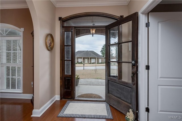 foyer featuring ornamental molding and hardwood / wood-style floors