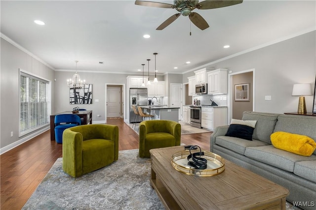 living area featuring recessed lighting, crown molding, baseboards, and wood finished floors