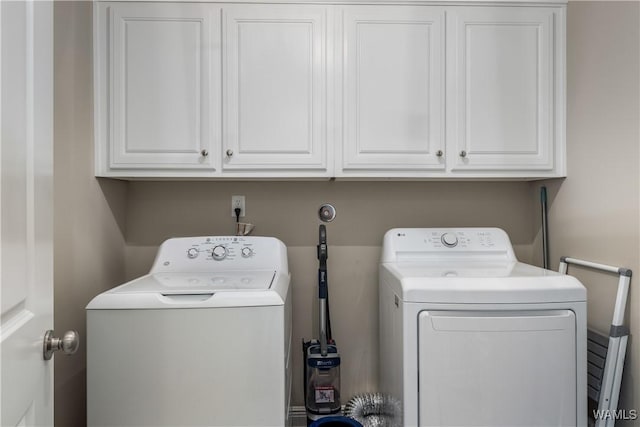 laundry room with cabinet space and washing machine and dryer