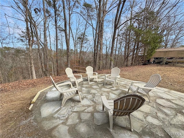 view of patio / terrace with a forest view