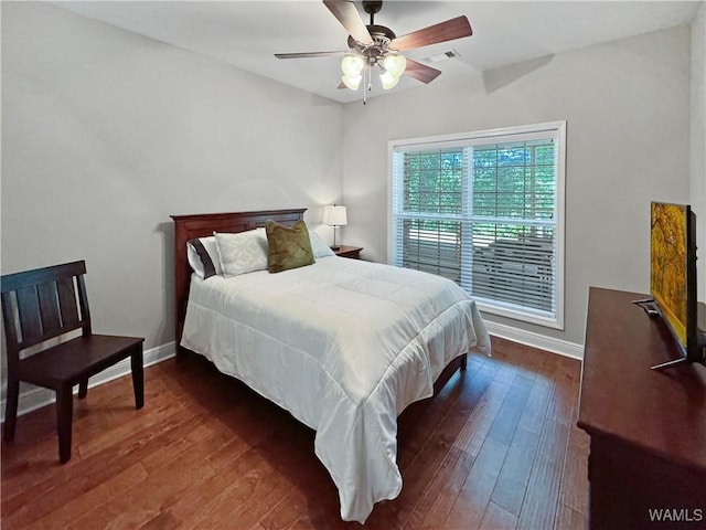 bedroom with a ceiling fan, visible vents, dark wood-style floors, and baseboards