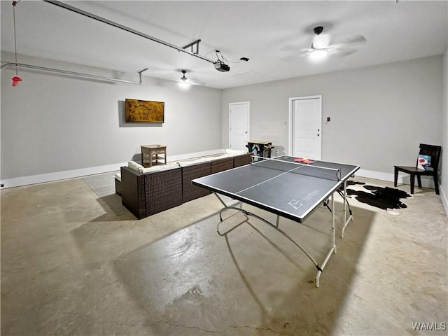 playroom with a ceiling fan, a garage, concrete floors, and baseboards