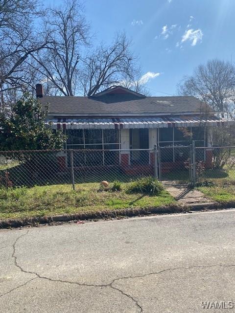 view of front of home with a fenced front yard and a gate