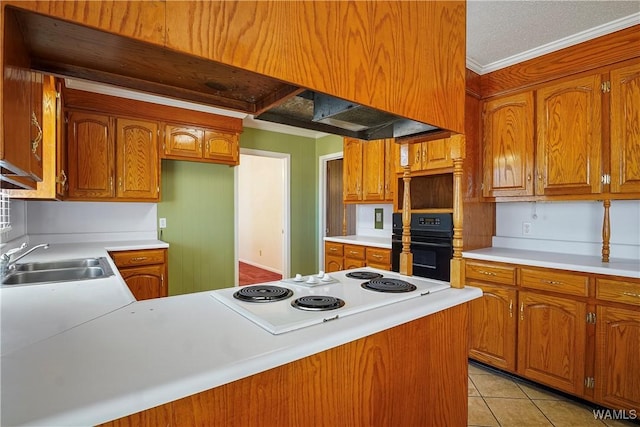 kitchen featuring sink, crown molding, white electric cooktop, light tile patterned floors, and black oven