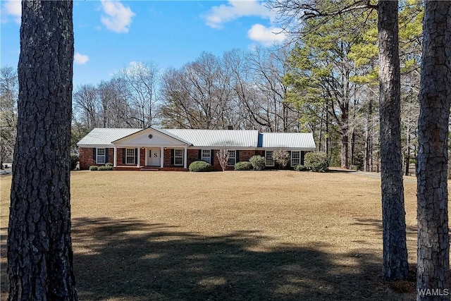 ranch-style house with a front yard and covered porch