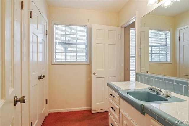 bathroom with vanity and decorative backsplash