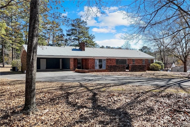 single story home featuring a carport