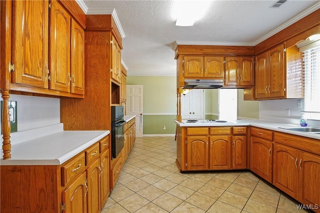 kitchen with white stovetop, black oven, sink, ornamental molding, and kitchen peninsula