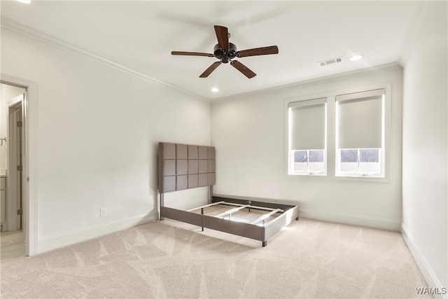 unfurnished bedroom featuring ceiling fan, ornamental molding, and light carpet