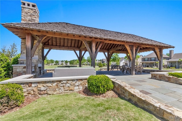 surrounding community with a gazebo and a patio area