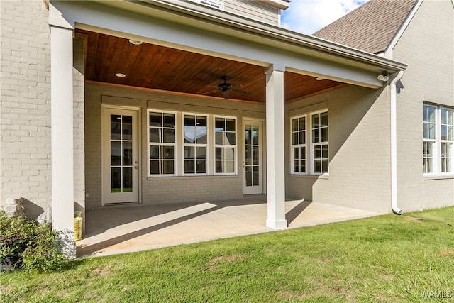 property entrance featuring a yard, ceiling fan, and a patio area