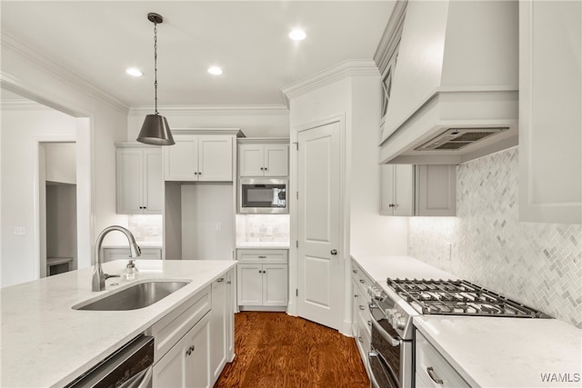 kitchen featuring custom exhaust hood, white cabinetry, sink, and stainless steel appliances