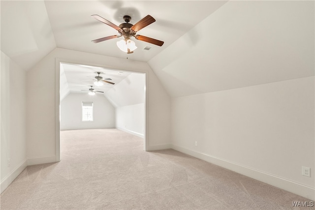 bonus room featuring ceiling fan, light colored carpet, and vaulted ceiling