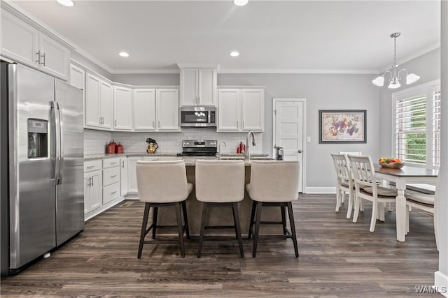10488 Nicole St, Vance, AL 35490 - kitchen featuring stainless steel appliances, ornamental molding, white cabinets, a chandelier, and backsplash
