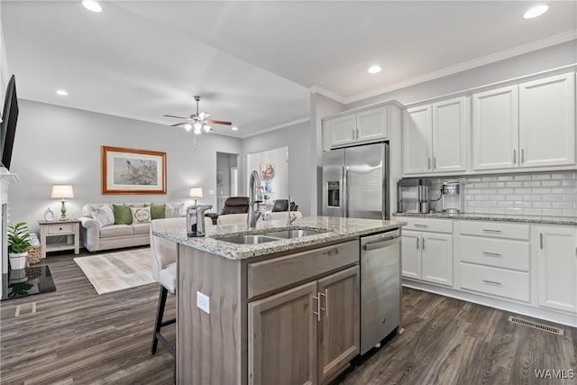 10488 Nicole St, Vance, AL 35490 - kitchen with appliances with stainless steel finishes, recessed lighting, white cabinetry, dark wood-type flooring, and an island with sink