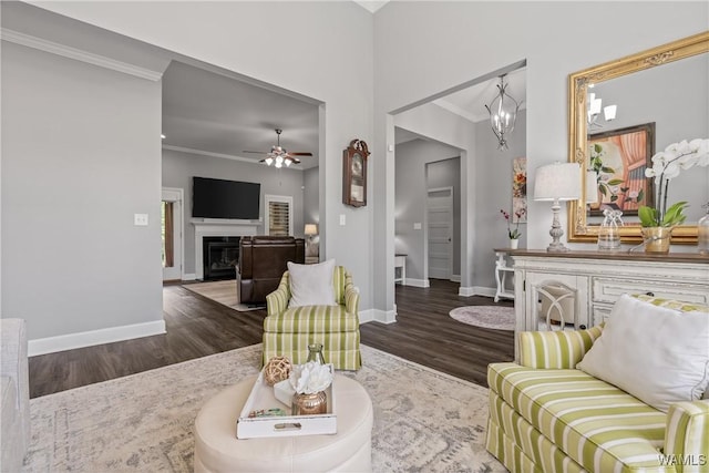 10488 Nicole St, Vance, AL 35490 - living area with crown molding, wood finished floors, ceiling fan, and a glass covered fireplace
