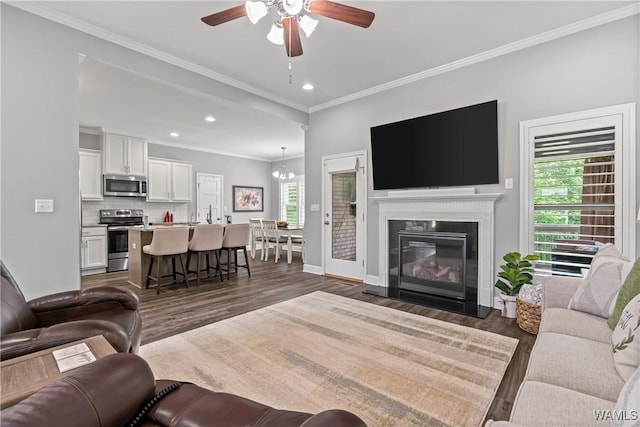 10488 Nicole St, Vance, AL 35490 - living room featuring dark wood finished floors, crown molding, ceiling fan, recessed lighting, and a fireplace with flush hearth