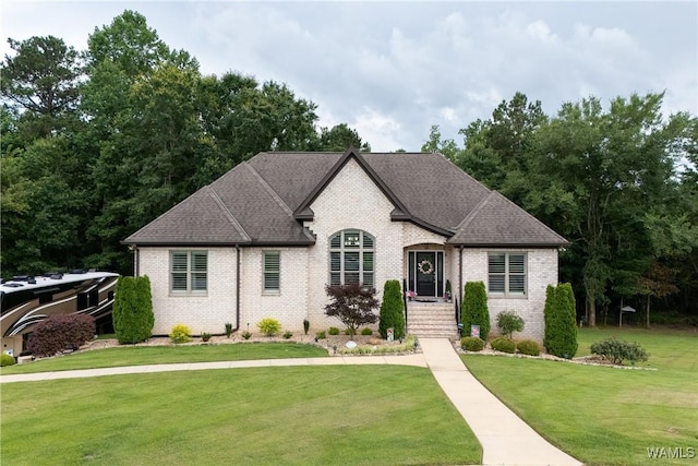 10488 Nicole St, Vance, AL 35490 - french country home with brick siding, a front yard, and roof with shingles