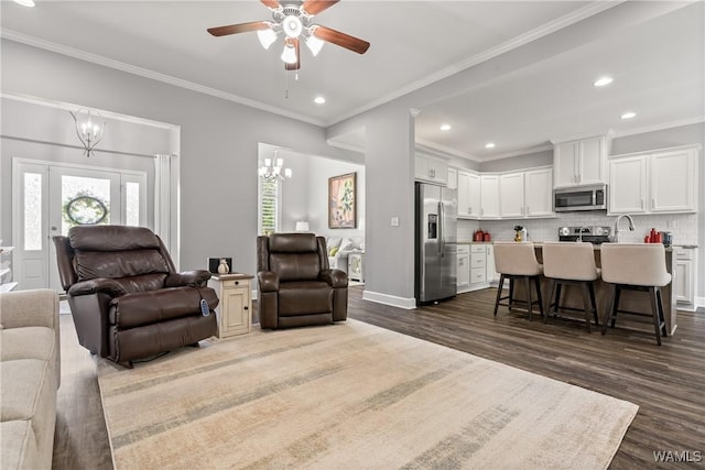 10488 Nicole St, Vance, AL 35490 - living area featuring dark wood-type flooring, ornamental molding, ceiling fan, recessed lighting, and a chandelier
