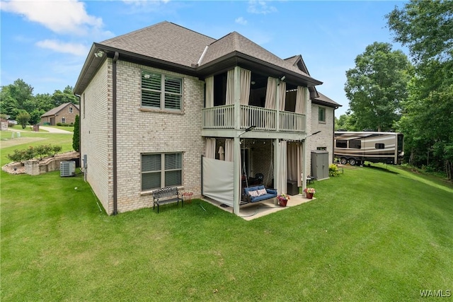10488 Nicole St, Vance, AL 35490 - back of property with a balcony, brick siding, a yard, and a patio