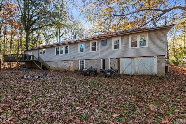 rear view of property with a wooden deck