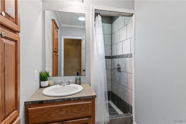 bathroom with crown molding, vanity, and walk in shower