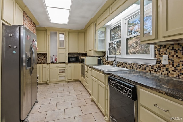 kitchen with black appliances, sink, light tile patterned floors, tasteful backsplash, and cream cabinetry