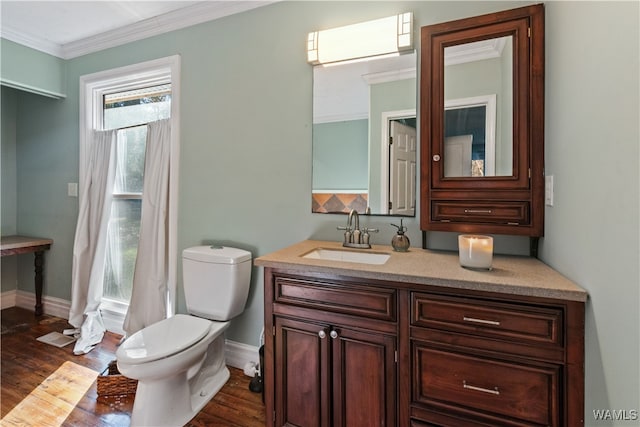 bathroom featuring hardwood / wood-style flooring, vanity, toilet, and ornamental molding