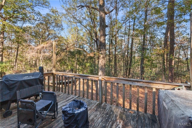 wooden deck featuring a grill