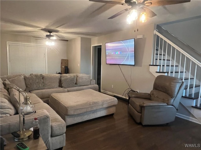 living room featuring dark wood-type flooring and ceiling fan