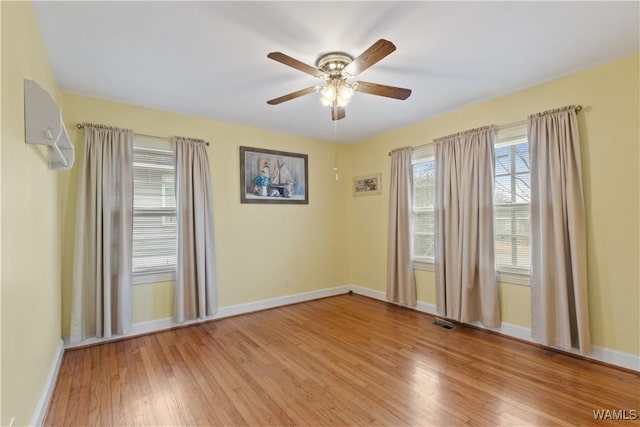 empty room featuring ceiling fan and light wood-type flooring