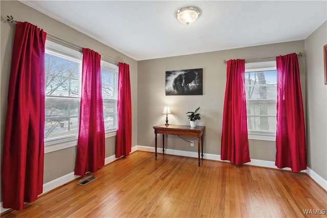 interior space with plenty of natural light and hardwood / wood-style floors