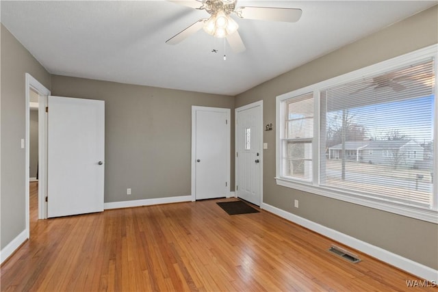 foyer entrance featuring ceiling fan and light wood-type flooring