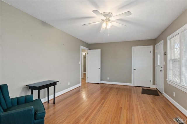 sitting room with light hardwood / wood-style flooring and ceiling fan