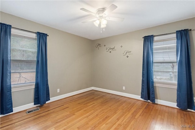 empty room with hardwood / wood-style flooring and ceiling fan