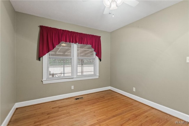 spare room featuring hardwood / wood-style flooring and ceiling fan