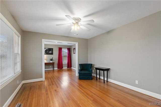 unfurnished room featuring ceiling fan, a healthy amount of sunlight, and light hardwood / wood-style flooring