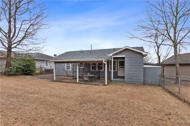 back of property featuring a yard and a patio area