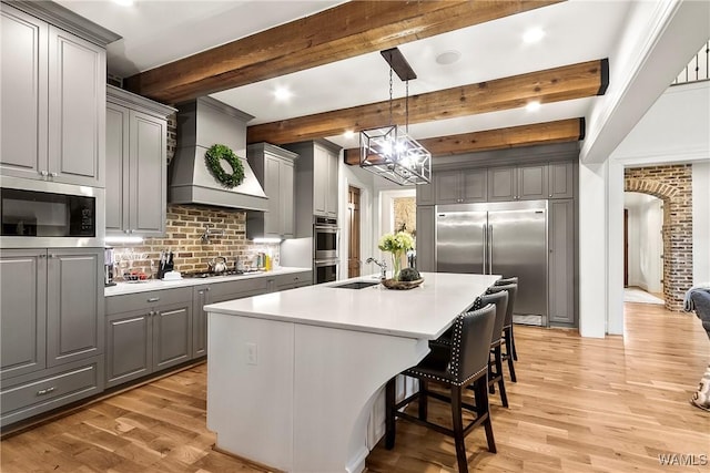 10300 Legacy Ln, Northport, AL 35475 - kitchen featuring gray cabinetry, premium range hood, built in appliances, a sink, and recessed lighting