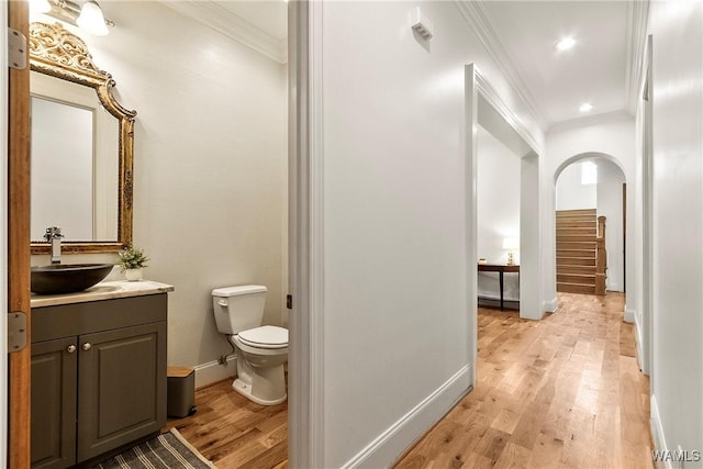 10300 Legacy Ln, Northport, AL 35475 - bathroom featuring crown molding, wood finished floors, toilet, baseboards, and vanity