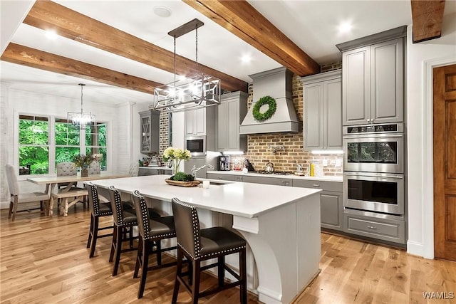 10300 Legacy Ln, Northport, AL 35475 - kitchen featuring a chandelier, custom range hood, appliances with stainless steel finishes, gray cabinets, and a sink