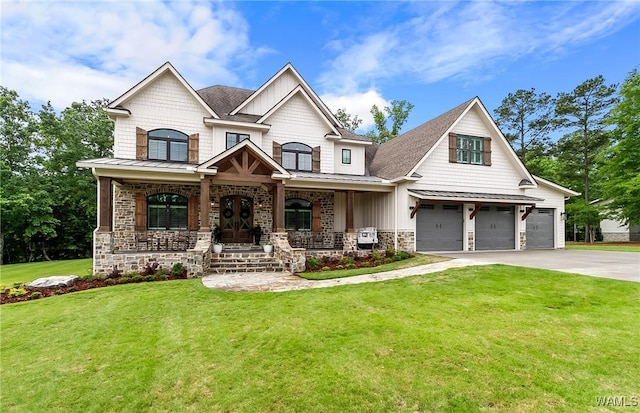 10300 Legacy Ln, Northport, AL 35475 - craftsman-style home with driveway, a porch, a standing seam roof, a front yard, and stone siding