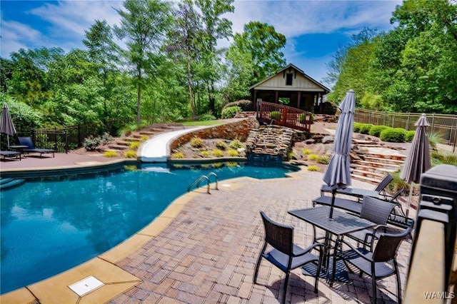 10300 Legacy Ln, Northport, AL 35475 - view of pool with a patio, fence, view of wooded area, and a water slide