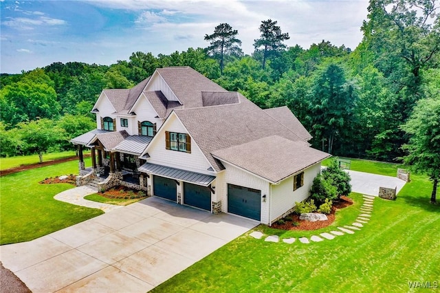 10300 Legacy Ln, Northport, AL 35475 - view of front of home featuring a porch, a standing seam roof, a shingled roof, concrete driveway, and a front lawn