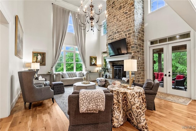10300 Legacy Ln, Northport, AL 35475 - living room featuring wood finished floors, a high ceiling, a chandelier, plenty of natural light, and a fireplace