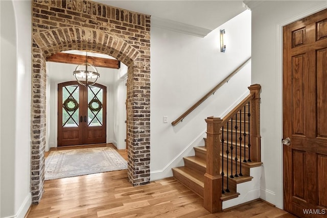 10300 Legacy Ln, Northport, AL 35475 - entryway featuring light wood finished floors, baseboards, a chandelier, and stairs