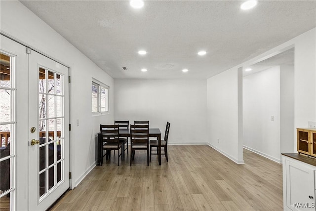 dining space featuring light wood finished floors, recessed lighting, baseboards, and french doors