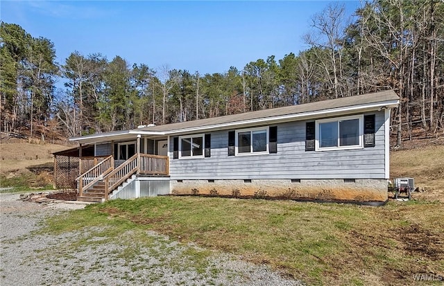 view of front of home with crawl space and a front lawn