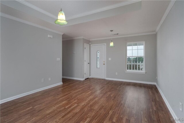 interior space featuring baseboards, dark wood finished floors, and ornamental molding